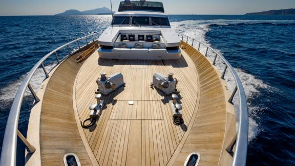 Experience a unique journey on the spacious foredeck of Sandi IV with a luxury yacht rental in Italy.